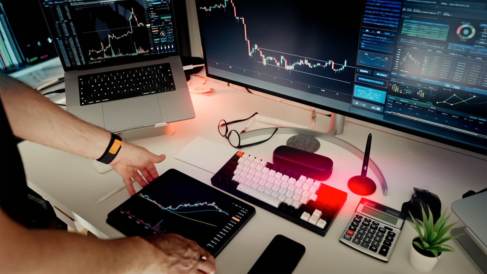 Multi-monitor setup showing cryptocurrency price charts