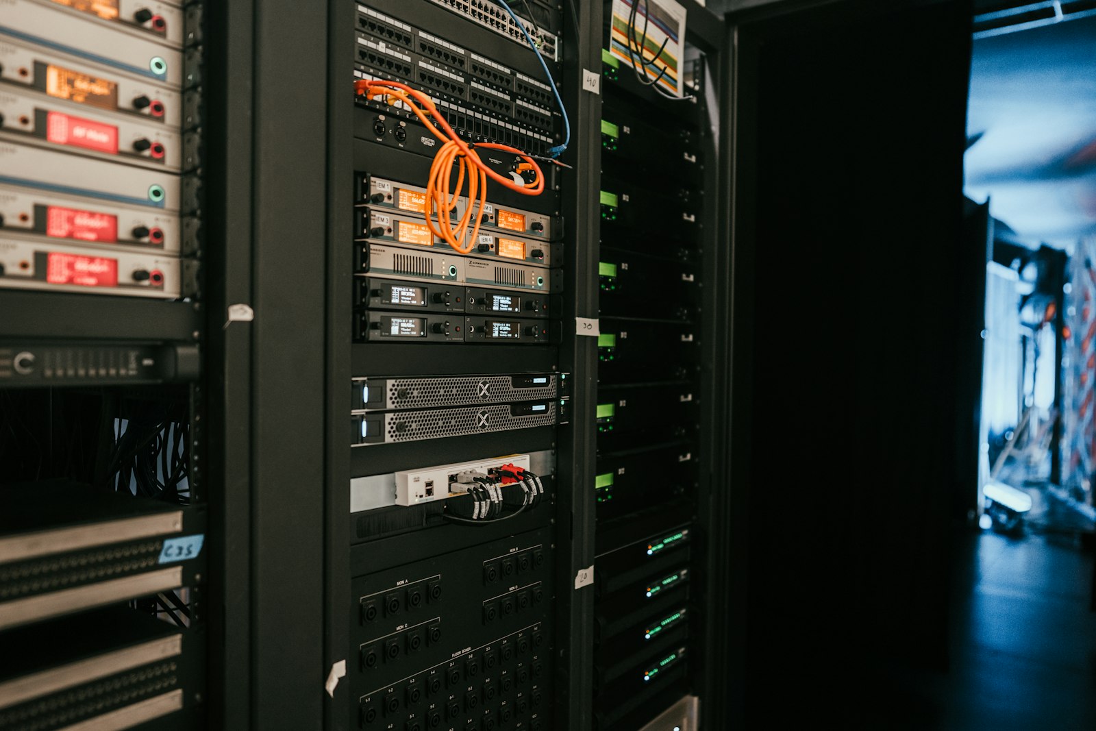 Dark server rack hardware with status LEDs, representing cloud infrastructure