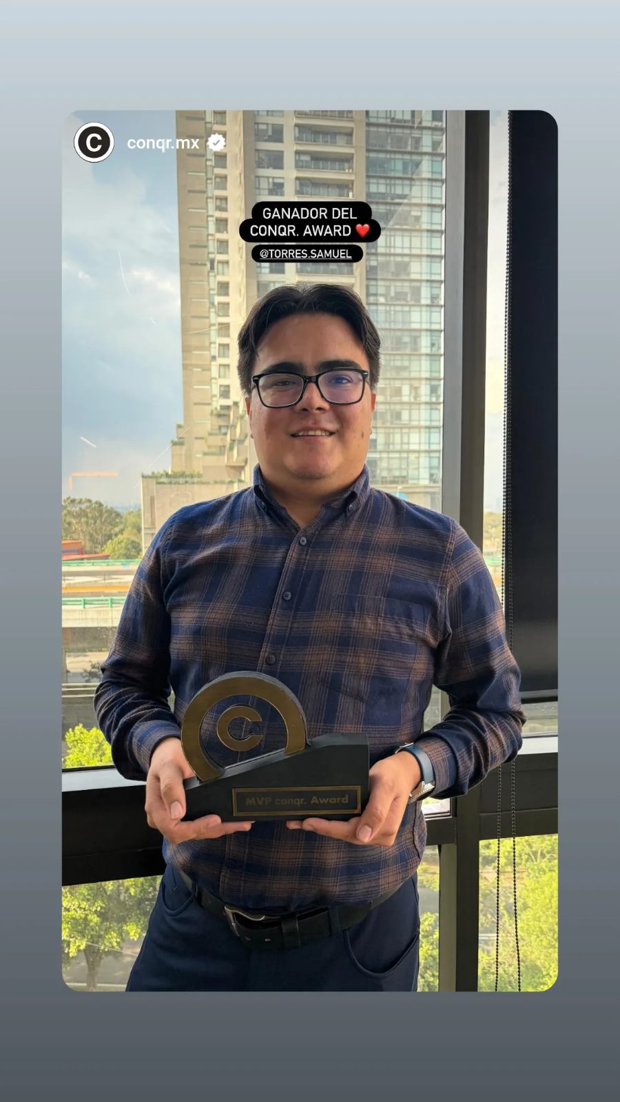 Samuel Torres holding the MVP conqr. Award trophy